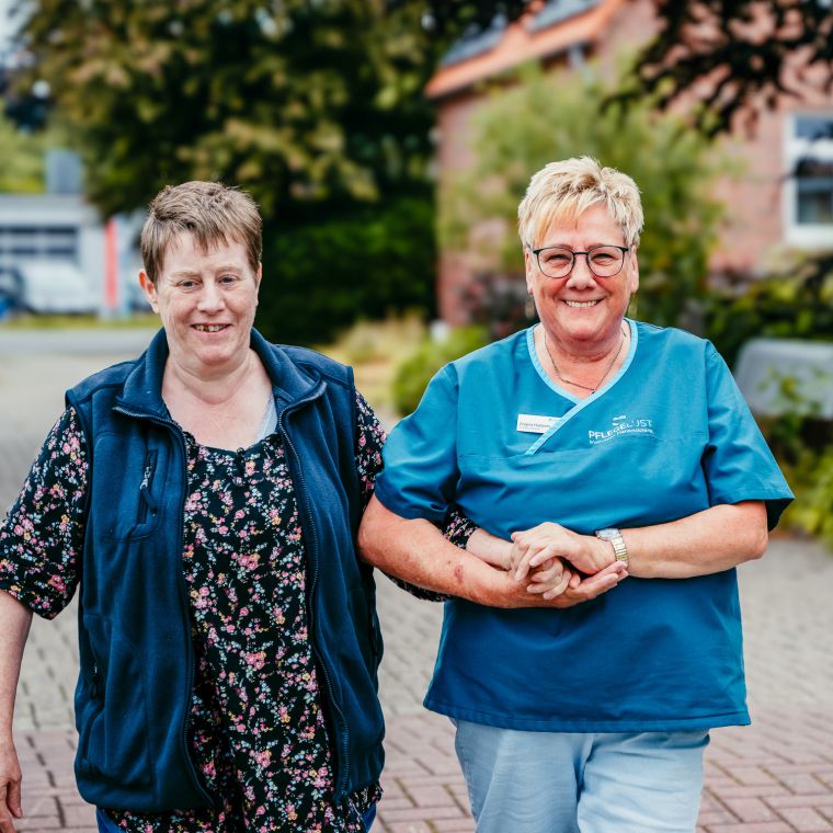 two women standing on a brick path